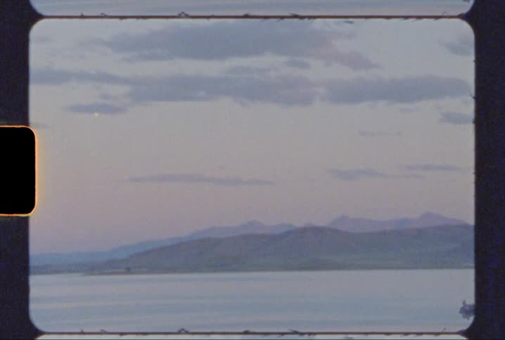 Mountains and a lake at sunset shot on 8mm film