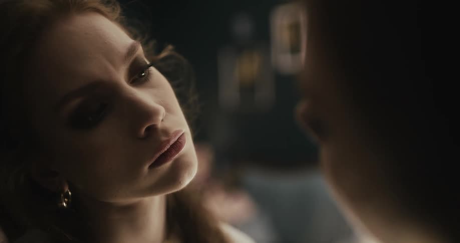 A woman gazes into the mirror