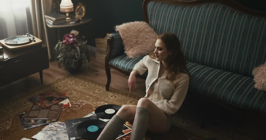 A woman sitting in a room on the floor
