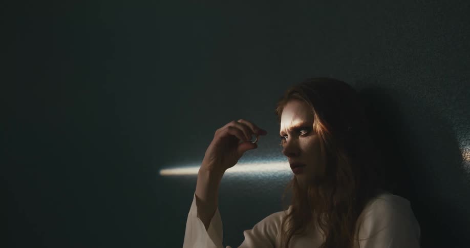 A woman twirls a ring between her fingers