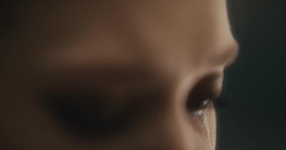 Tear track sits under womans teary eye
