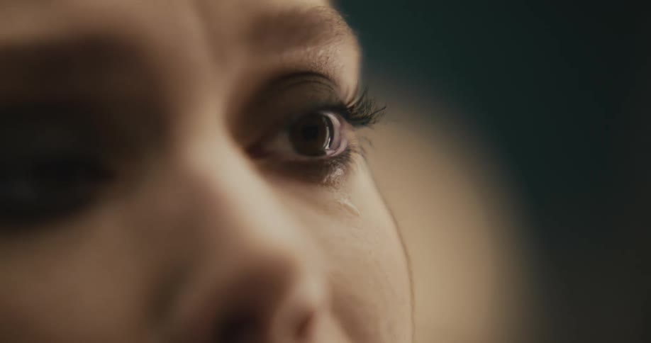 A woman wearing eye makeup crying