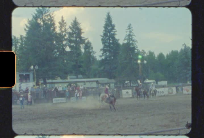 vintage rodeo footage of a man getting bucked off a horse in Montana shot on 8mm film