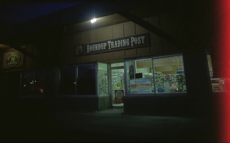 The exterior of a trading post store at night shot on 16mm film