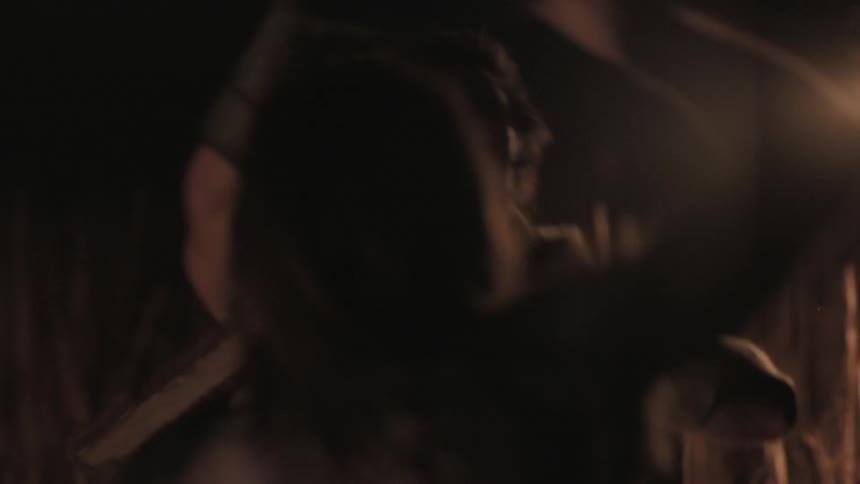 Viking like men fighting in a field by fire at night