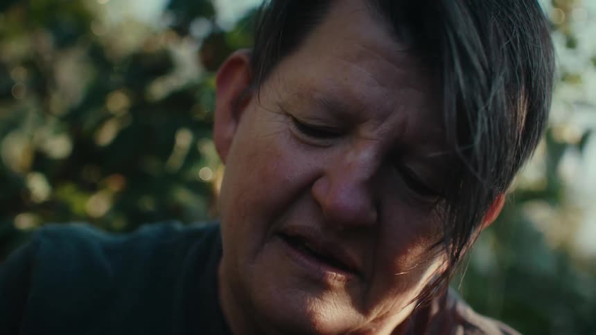 Close up of the face of a mature woman watching his crops on a farm at morning