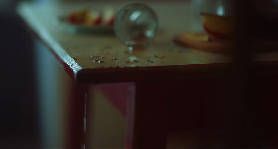 A drink has been spilled on a counter next to some food