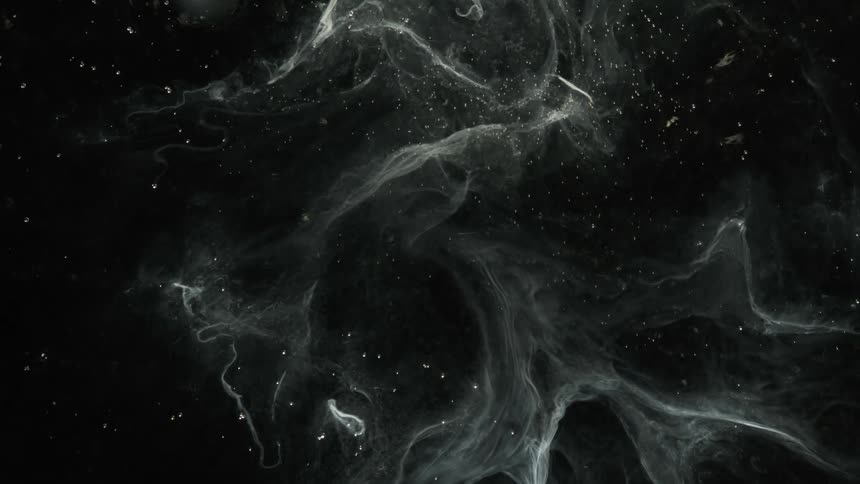 A smokey substance is floating in the darkness among the stars