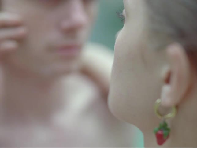 A woman is caressing a mans face