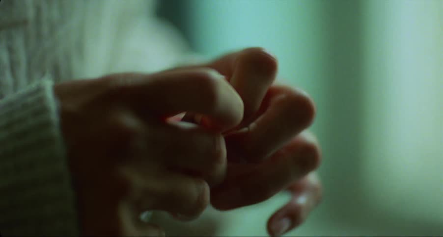 Close up of the hands of a woman taking a pill out of a blister