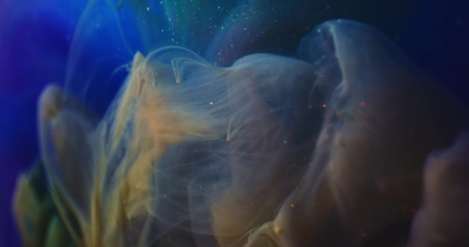 Cloud of dark ink blobs flowing down a blue glittering liquid