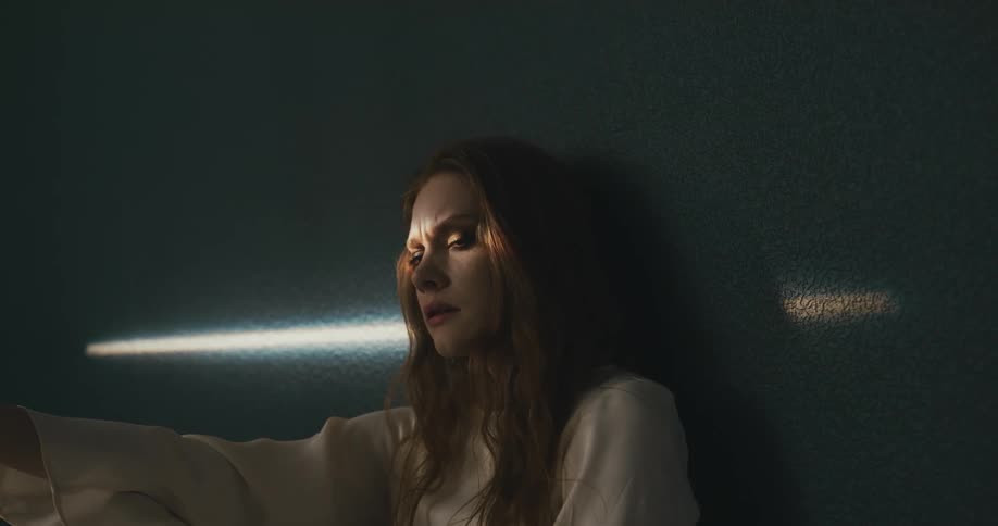 A young woman thinking and pondering while leaning against a wall