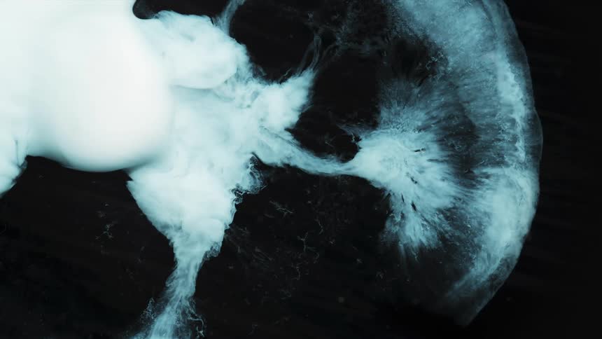 White floating ink shaped like an iris erupting and contracting over a dark background