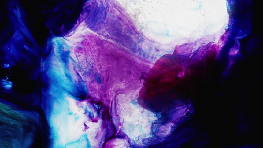 Colorful dyes and paints ebb and flow in clear liquid