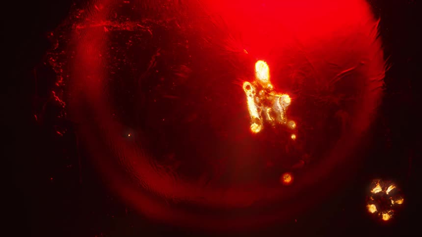 Light like a flame expands into a yellow and white liquid