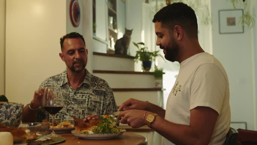 Happy couple eating a meal together in the dinner table at home