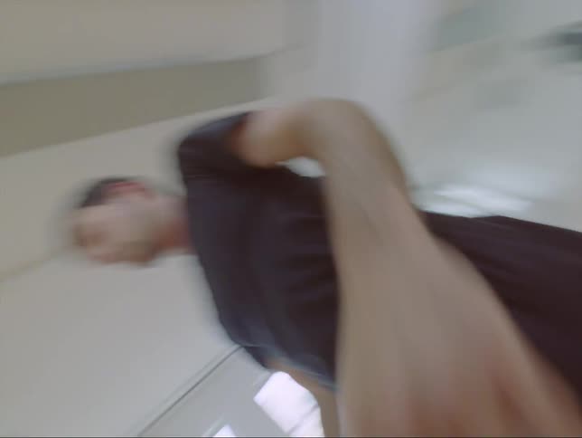 There is a young white man dancing inside of a studio