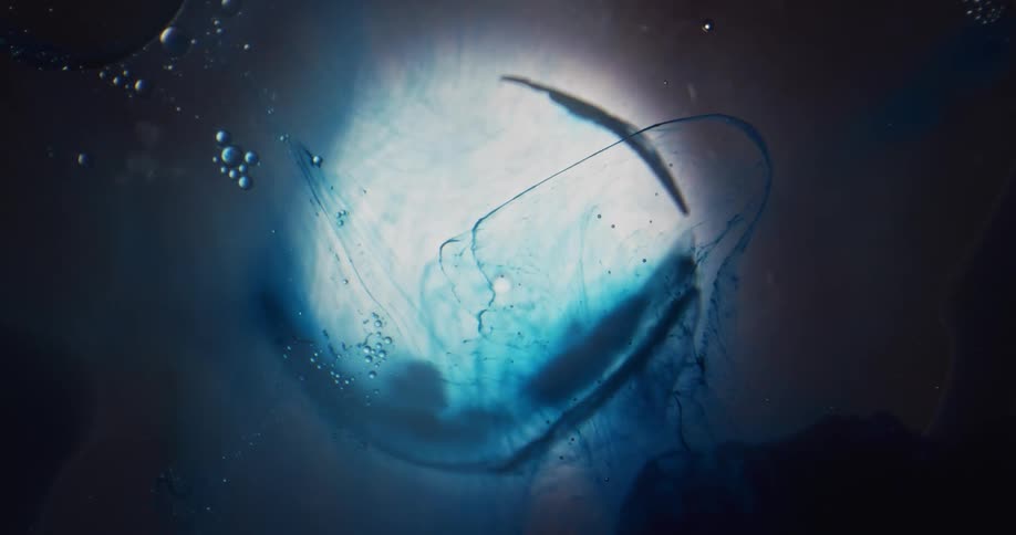 Abstract footage of bubbles in liquid with blue dye