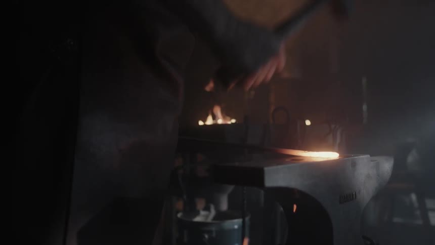 A blacksmith hammering a piece of iron