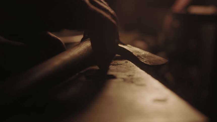 A man places his axe on a table