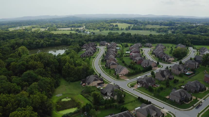 Aerial view of houses on a luxurious neighborhood in the suburbs close to the countryside