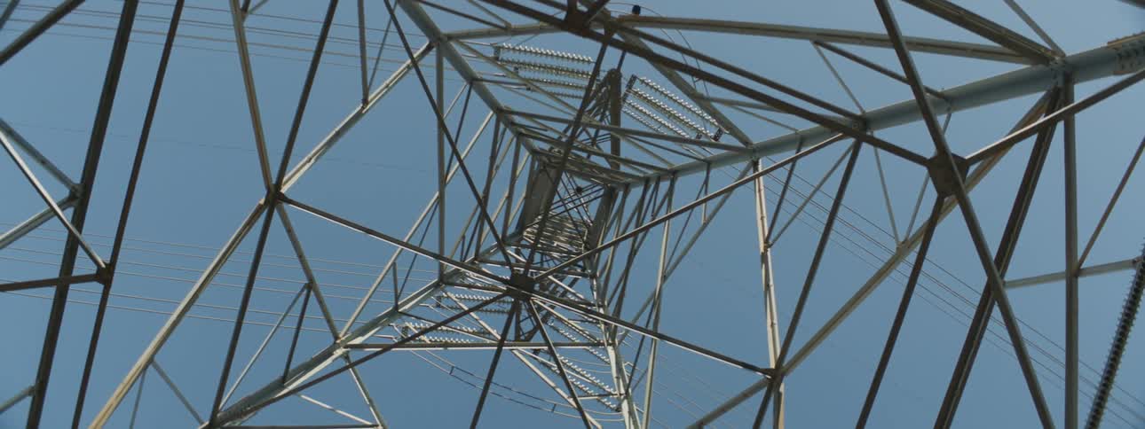 A shot of a utility tower from the bottom looking up