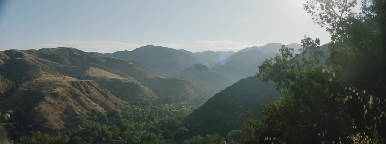 Farms and houses on a narrow valley between mountains at morning