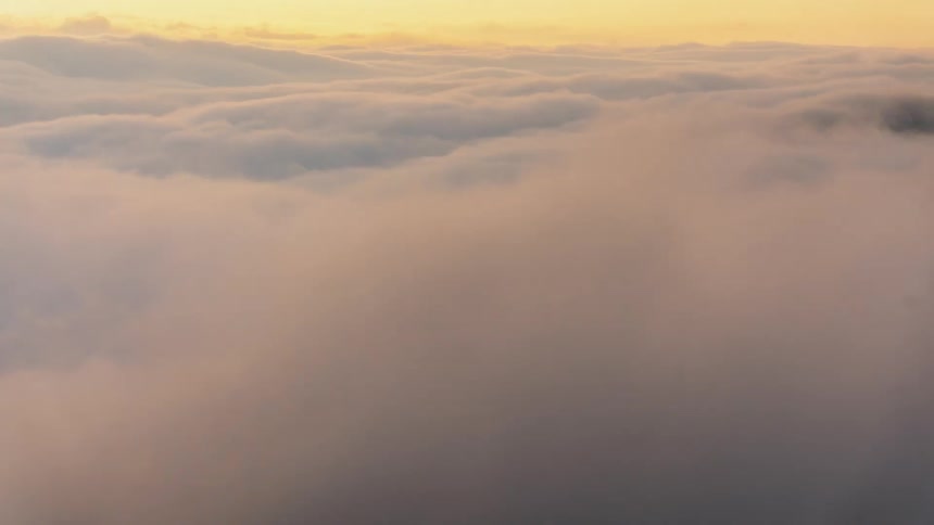 Clouds float vividly across the sky and over mountain tops