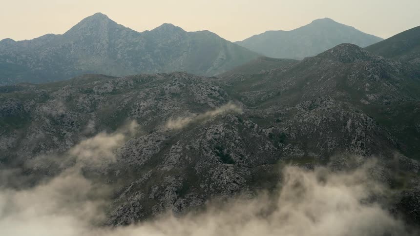 Clouds gather than clear over the slopes of a mountain range in Northern Spain