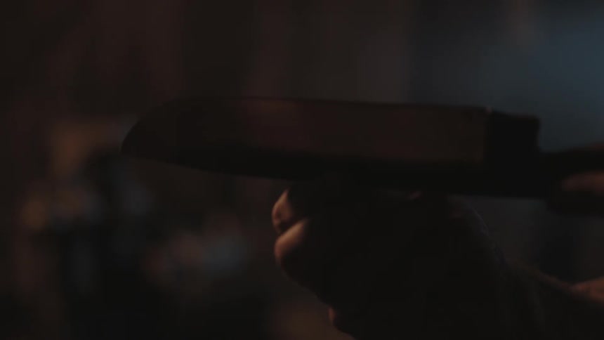 A man running his fingers along a knife