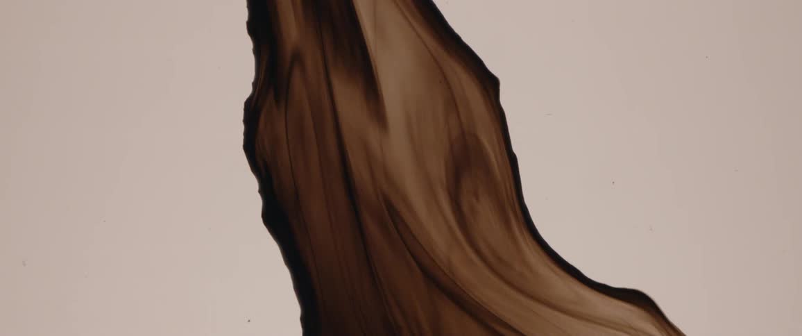 Abstract footage of brown liquid paint flowing