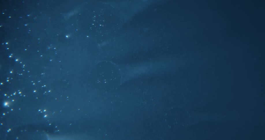 Bubbles float on the side of the liquid