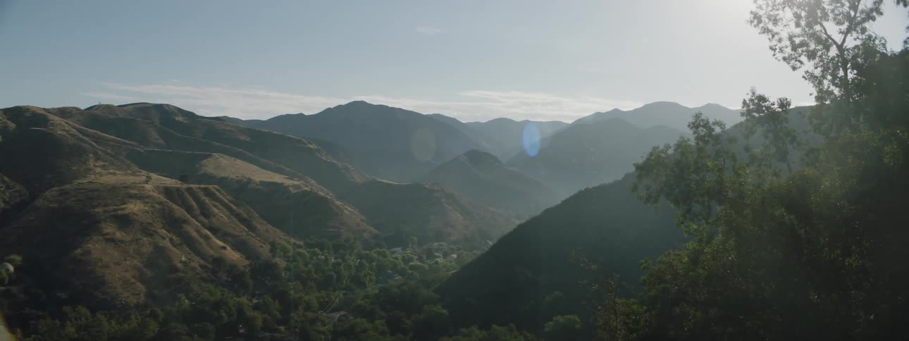 Haze hangs over a valley in the mountains