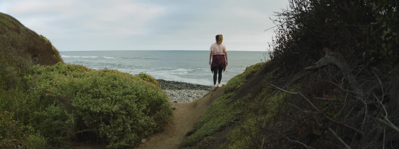A woman runs to the shore