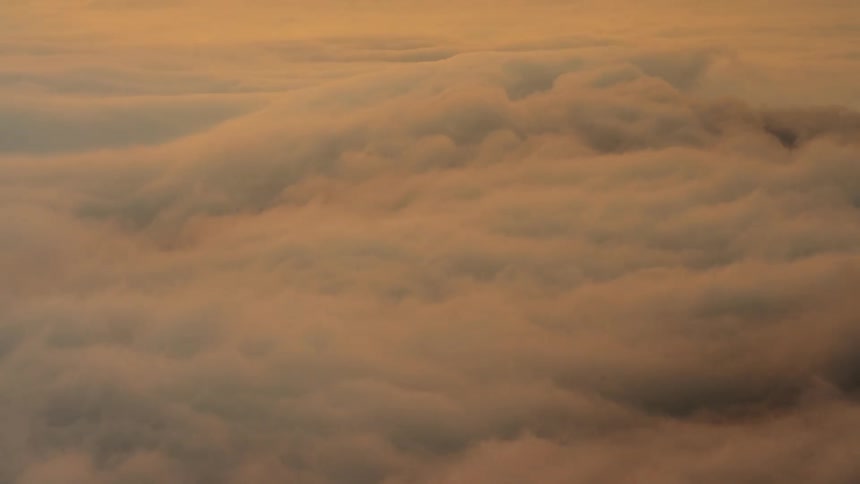 The white clouds swirl around at sunrise