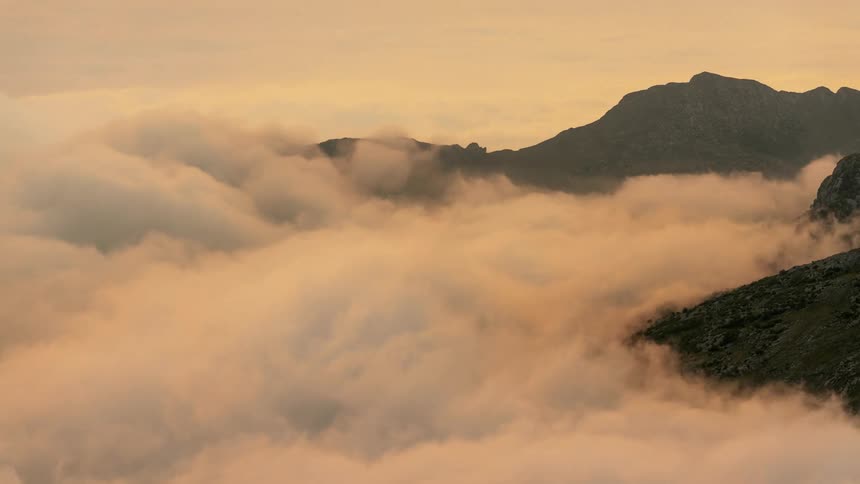 Time lapse of clouds moving over a mountain range