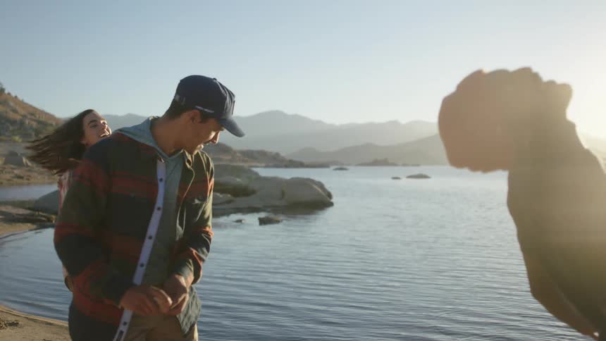 Campers are skipping rocks in the lake