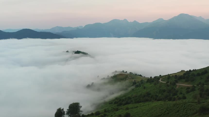 Clouds covering a hillside in the green province of Asturias