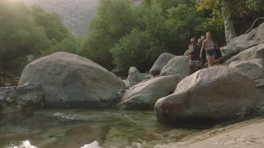 People climb over the boulders together