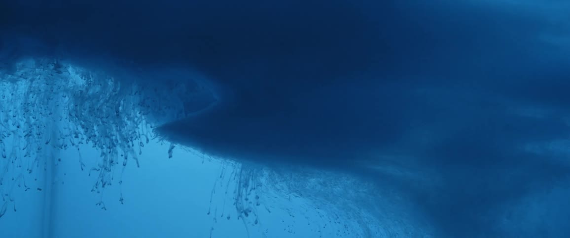 Clouds of intense dark liquid ink flowing and swirling down a water tank