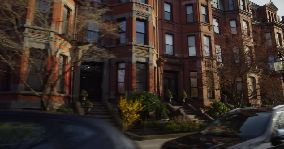 Cars parked in front of the apartment buildings on a neighborhood in the city at morning