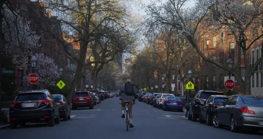 A man is riding his bicycle down the street