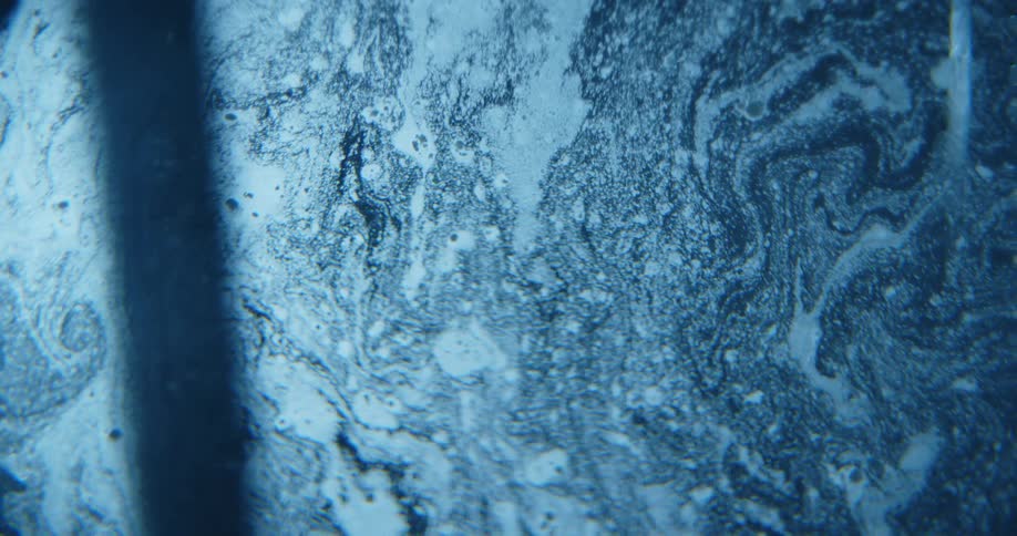 Blue water flowing and swirling