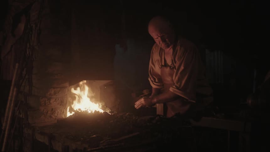 A fire burns in a blacksmith shop