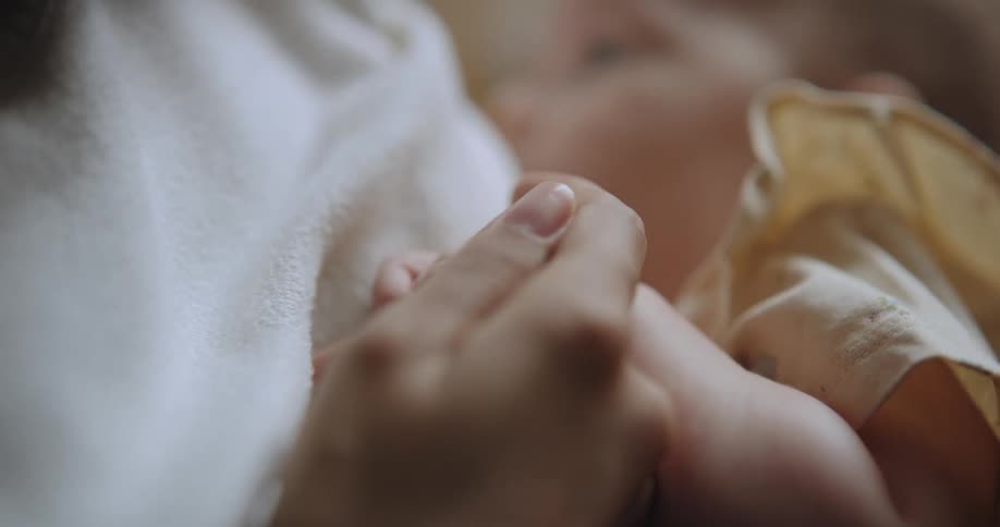 A mother is holding her baby