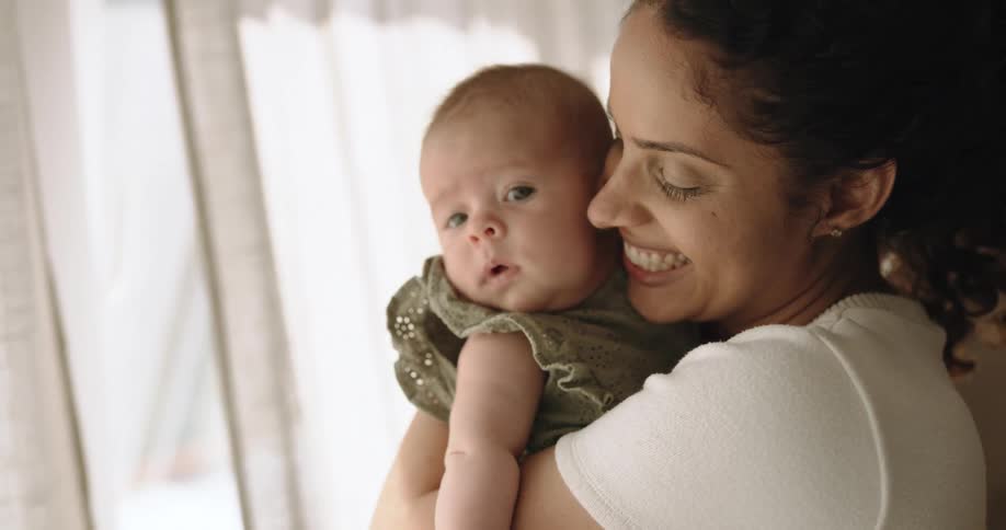 A mother holds her baby in her arms