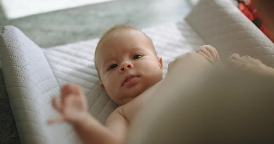 A baby is being dressed