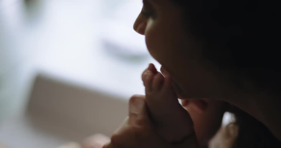 A mother plays with her baby