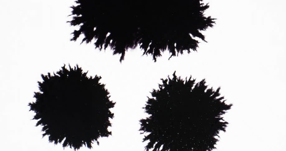 Black splotches impact on white background and spread