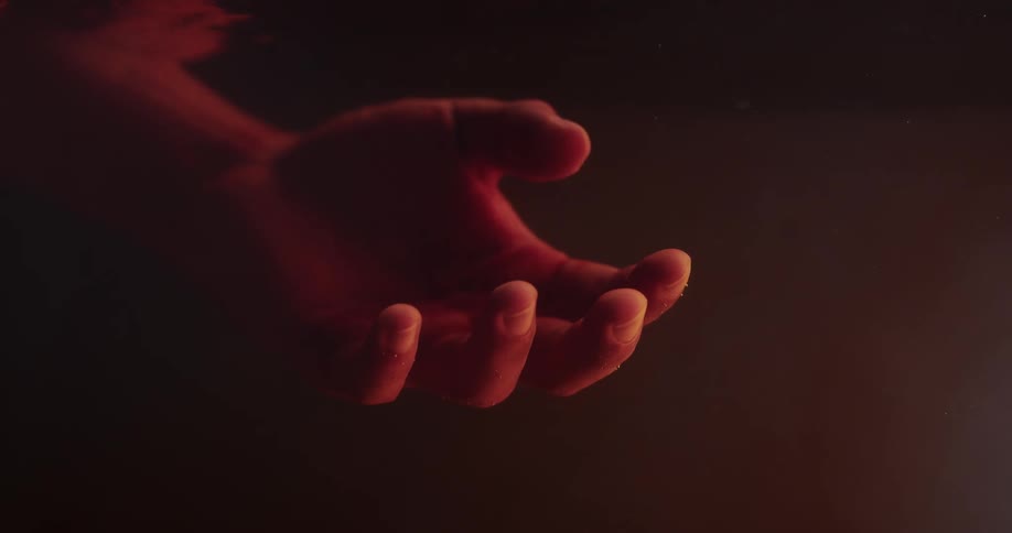 A person lies in a pool with their arms outstretched